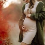 Beautiful pregnant woman feeling lovely in the park. Motherhood. Maternity. Lifestyle concept.
